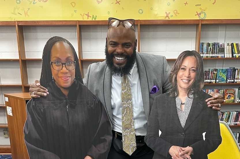 Candido Brown with posters of KBJ and VP Harris